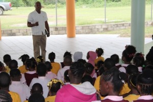 Emergency Operations Specialist of the Caribbean Disaster Emergency Management Agency (CDEMA) based in Barbados Retired Brigadier General Earl Arthurs, tells students of the Elizabeth Pemberton Primary School on Nevis the importance of taking instructions during a disaster on May 27, 2013