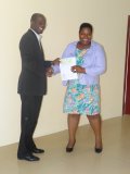 Hon. Patrice Nisbett handing over a WISE check to Miss Cavell Mills (Picture by Gavincia David)