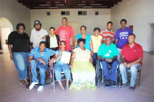 Class members pose for a group picture at the McKnight Community Centre. Mr Geoffrey Hanley is sitting on the right and next to him is Mr Anthony Mills.