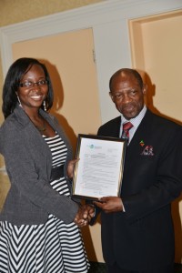 St. Kitts and Nevis’ Prime Minister the Rt. Hon. Dr. Denzil L. Douglas (right) presents certificate to Ms. Hadassah Willett of Nevis to study medicine. 