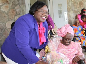 Minister of Social development who is responsible for the welfare of the seniors on Nevis Hon. Hazel Brandy-Williams hands over a fruit basket to 103-year-old Celian “Martin” Powell during her birthday celebration on January 19, 2015, at the Flamboyant Nursing Home