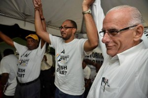 Jonel Powell flanked by Sir Kennedy Simmonds and Dwyer Astaphan