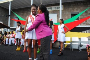 Mrs Jean Alcendor-Browne, the Development Bank’s Credit Risk Management Officer in the Nevis Branch adorning Ms Jonieka Smithen with the bank’s sash.