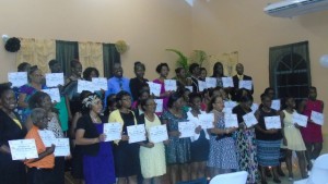 Graduating class with tutor Sylvester Wallace at back in blue shirt