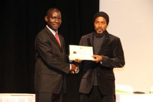 Photographer Sylvester Meade, the first winner of the Ministry of Tourism’s Amateur Photographer of the Year contest accepting the winner’s certificate from John Hanley, Assistant Secretary in the Ministry of Tourism at the awards ceremony in 2016 (file photo